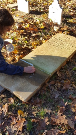 Kristin Cardi repairs a headstone